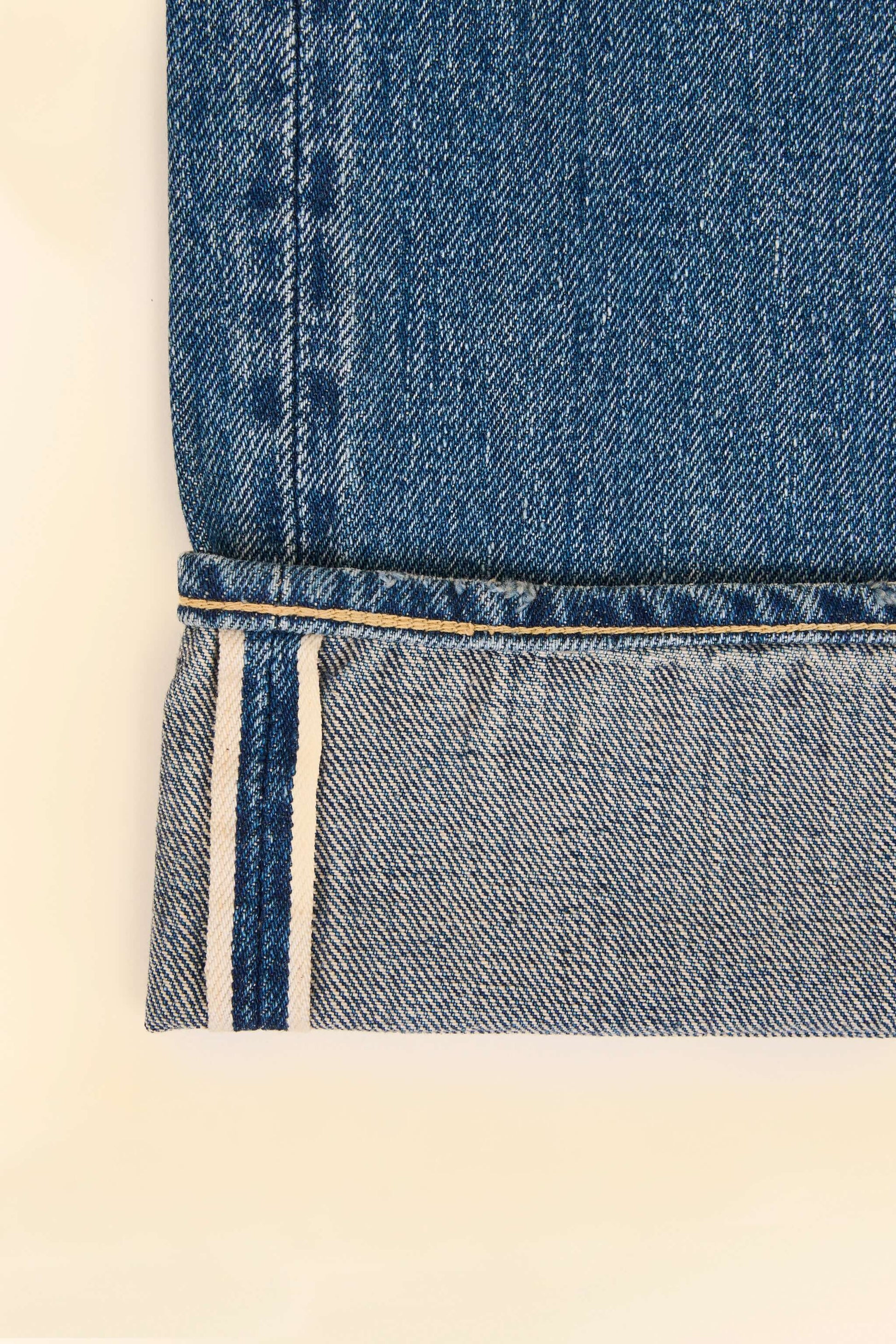 Godspeed 1950UV Selvedge Jeans – vintage wash chain-stitched hem and roping and selvedge ID close-up.