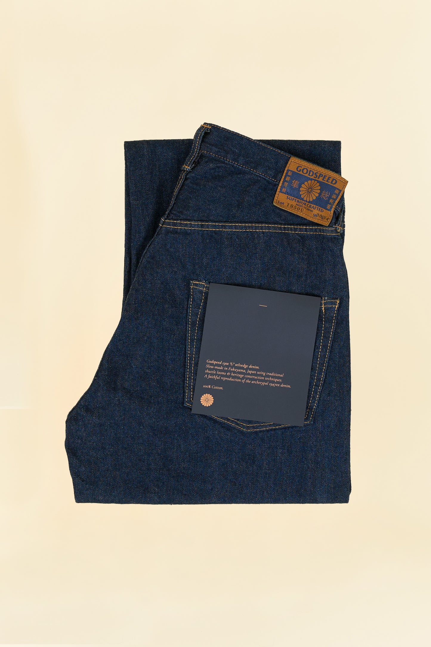 Godspeed 1950 “U” 13oz Wide-Straight Japanese Selvedge Jeans – folded view showing environmentally printed label and leather patch
